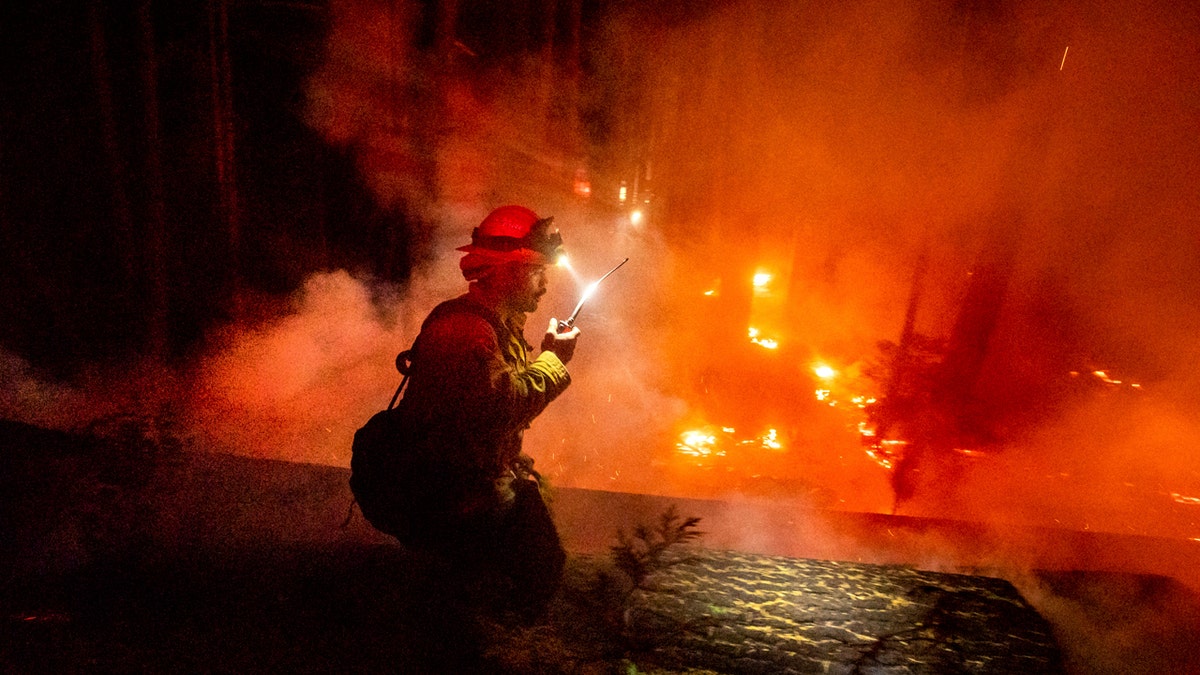 A firefighter battles the Creek Fire in the Shaver Lake community of Fresno County, Calif., on Monday, Sept. 7, 2020.
