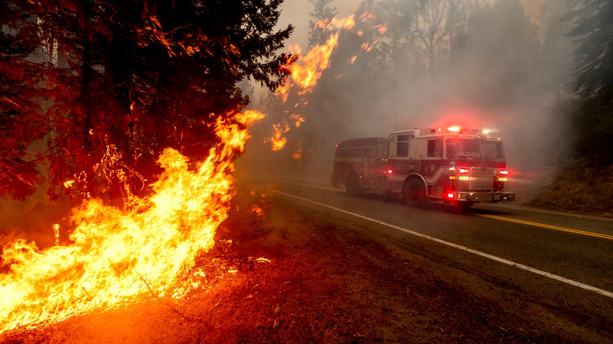 A firetruck drives along state Highway 168 while battling the Creek Fire in the Shaver Lake community of Fresno County, Calif., on Monday, Sept. 7, 2020.
