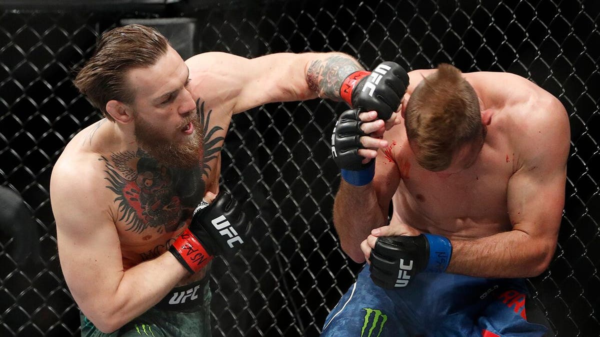 Conor McGregor hits Donald "Cowboy" Cerrone during a UFC 246 welterweight mixed martial arts bout Saturday, Jan. 18, 2020, in Las Vegas. (AP Photo/John Locher)