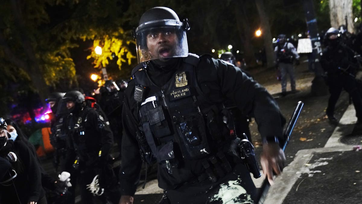 Portland police officer photographed push crowd back during riot in 2020