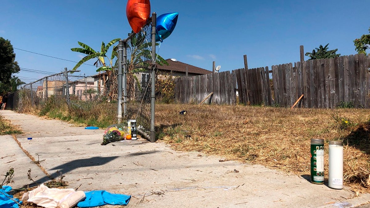 Balloons, candles and flowers are left on Tuesday as a memorial for Dijon Kizzee where he was fatally shot by Los Angeles sheriff's deputies the day before in the Westmont section of Los Angeles. (AP Photo/Stefanie Dazio)