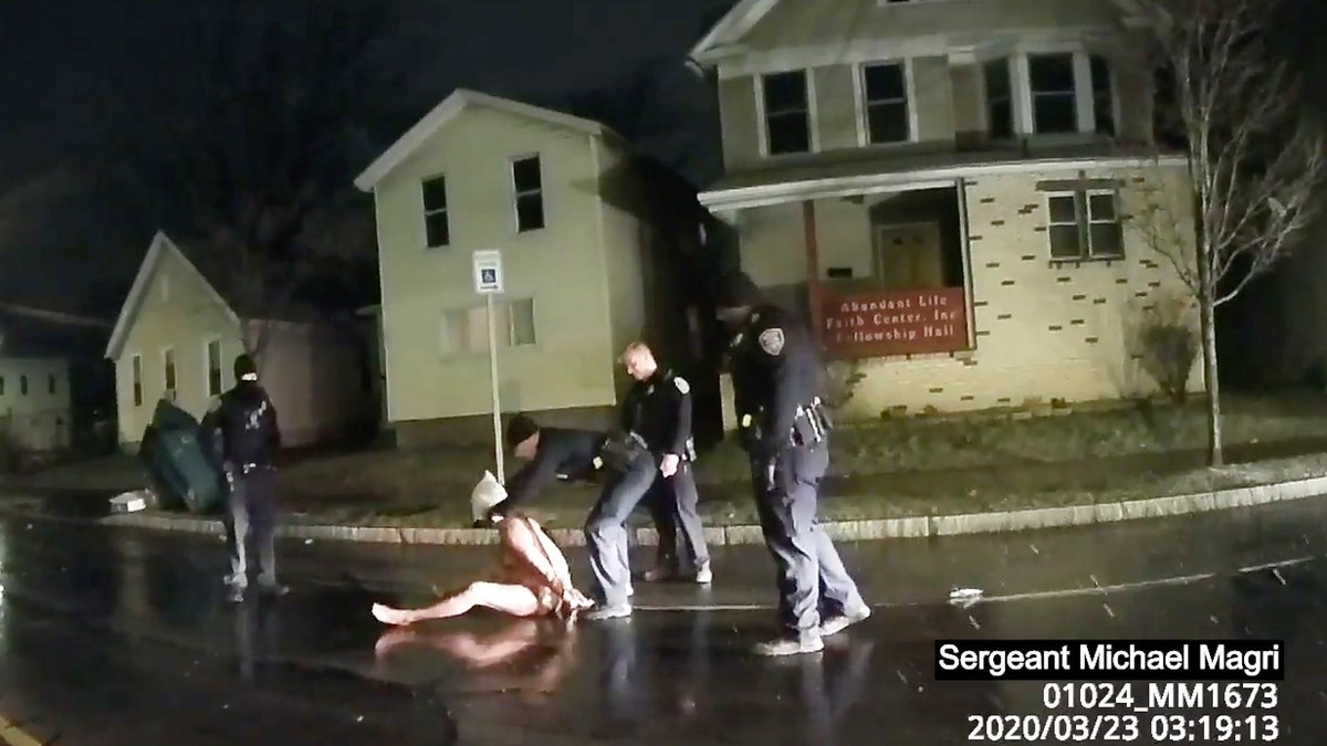 In this image taken from police body camera video provided by Roth and Roth LLP on Sept. 2, 2020, a Rochester police officer puts a hood over the head of Daniel Prude, on March 23, 2020, in Rochester, N.Y. (Rochester Police via Roth and Roth LLP via AP)