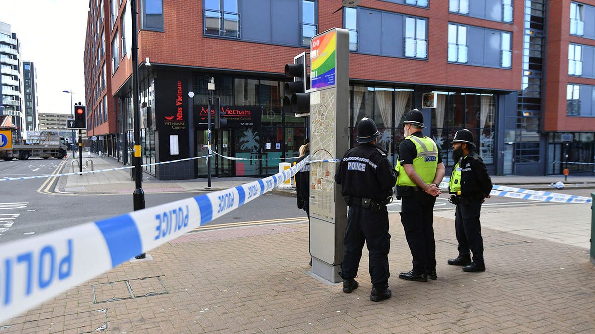 Police officers stand at a cordon in Hurst Street in Birmingham after a number of people were stabbed in the city centre on Sunday. (Jacob King/PA via AP)