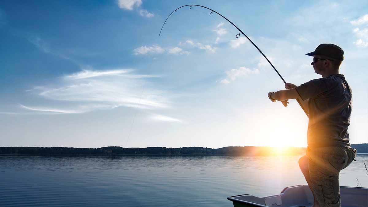 Man fishing in body of water