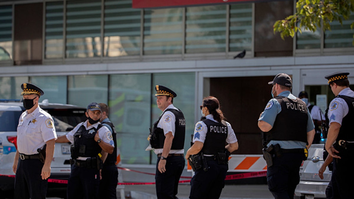 Chicago police officers gather outside the emergency area of Stroger Hospital after two officers were wounded in a shooting during a traffic stop in the Homan Square neighborhood early Sunday, Aug. 30, 2020. (Erin Hooley/Chicago Tribune/Tribune News Service via Getty Images)