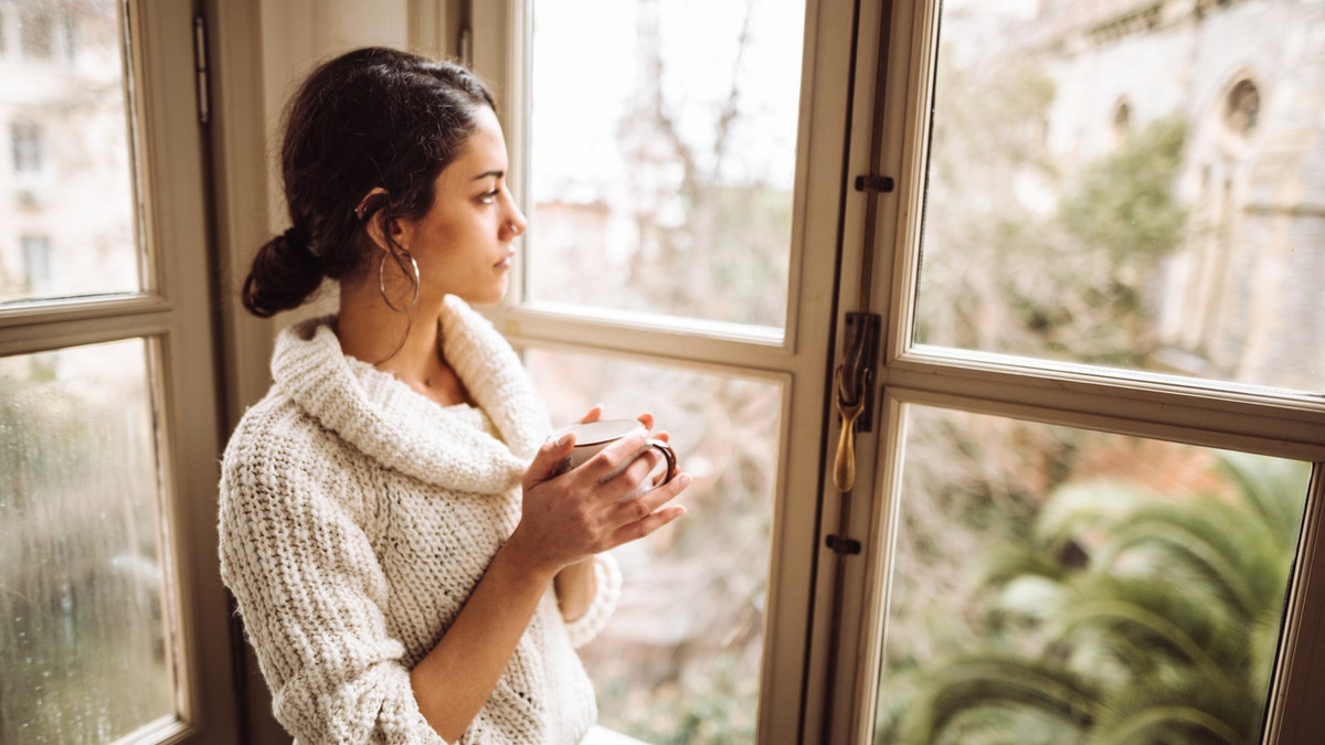 sad woman at window