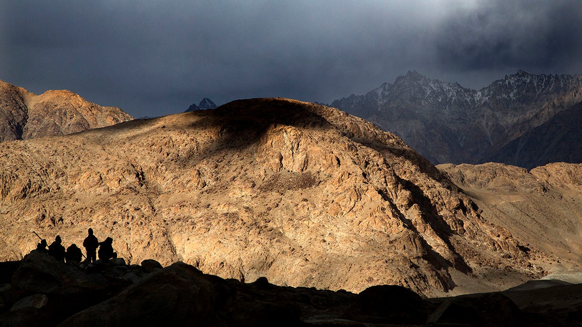 In this Sept. 14, 2018, file photo, Border Roads Organization workers rest near Pangong Lake in Ladakh region, India. (AP Photo/Manish Swarup, File)