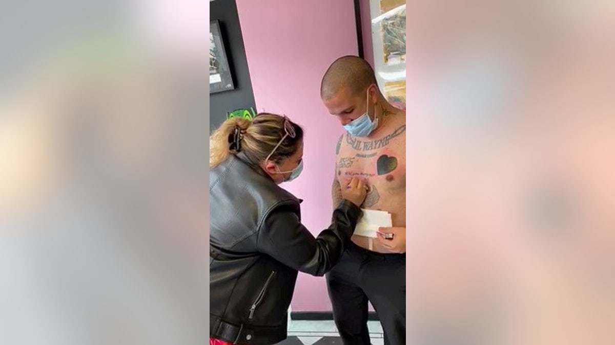 Bruno Neves. from Great Yarmouth, U.K., popped the question to his girlfriend Patricia Calado with a tattoo that read "Will you marry me?" (SWNS)