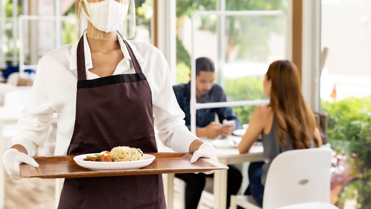 waitress serving food new normal.