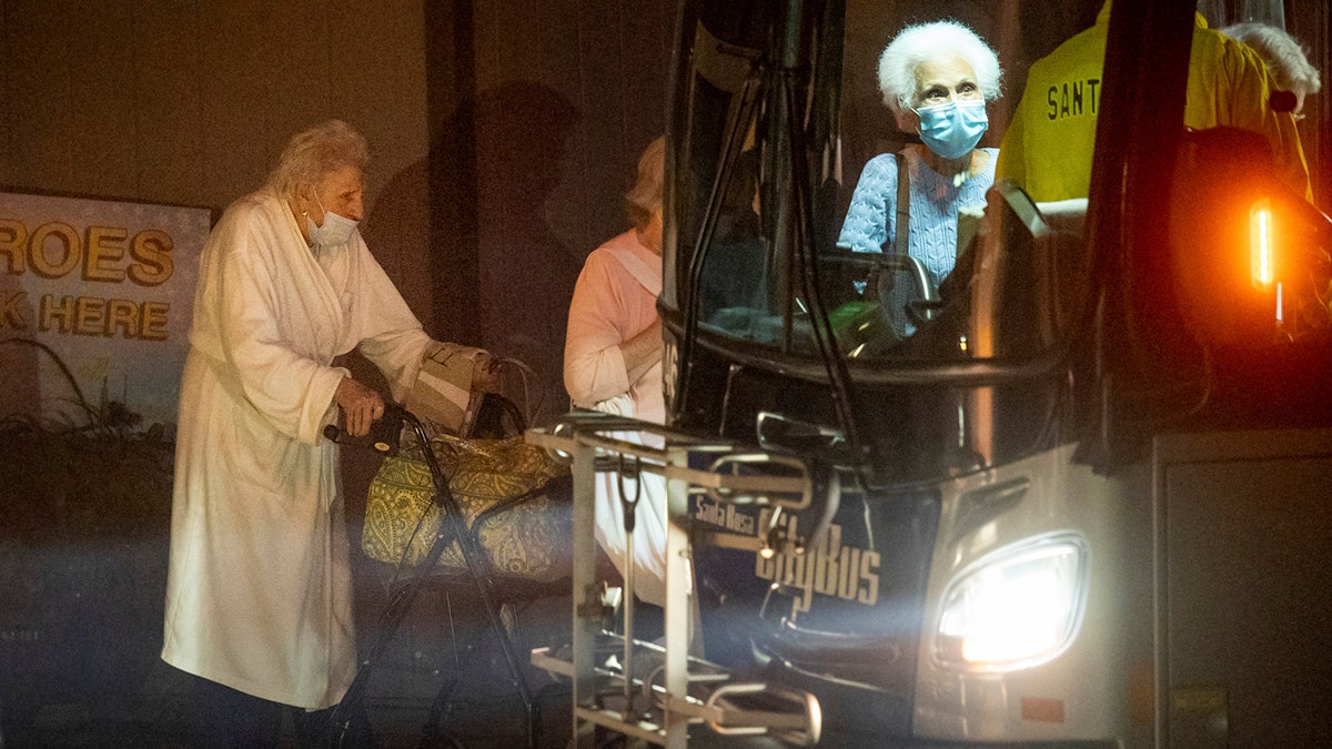 Residents of the Oakmont Gardens senior home evacuate by bus as the Shady Fire approaches Santa Rosa Calif., Monday, Sept. 28, 2020.