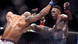 FILE- In this March 7, 2020, file photo, UFC middleweight champion Israel Adesanya, right, of Nigeria, kicks challenger Yoel Romero, of Cuba, during the second round of their UFC 248 fight at the T-Mobile Arena in Las Vegas. Israel Adesanya returns to the UFC cage this weekend to defend his middleweight title against Paulo Costa in the main event of UFC 253.  (L.E. Baskow/Las Vegas Review-Journal via AP, File)