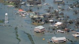 FILE - In this Aug. 27, 2020, file photo, buildings and homes are flooded in the aftermath of Hurricane Laura near Lake Charles, La. Climate-connected disasters seem everywhere in the crazy year 2020. But scientists Wednesday, Sept. 9, say it'll get worse. (AP Photo/David J. Phillip, File)