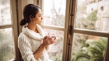 sad woman at window