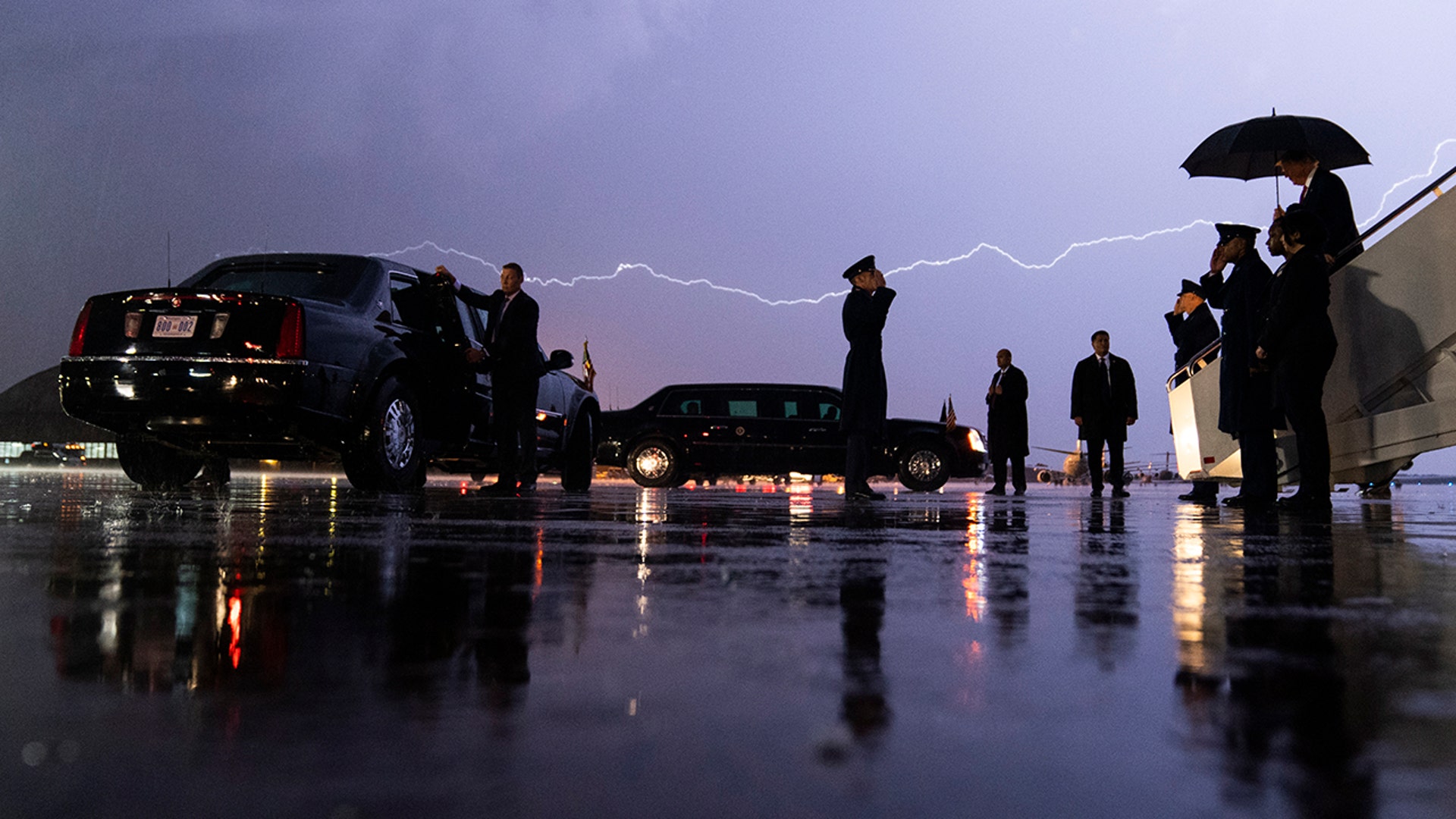 A lightning strike moves across the sky as President Trump arrives during a storm at Andrews Air Force Base, Maryland, Aug. 28, 2020. 