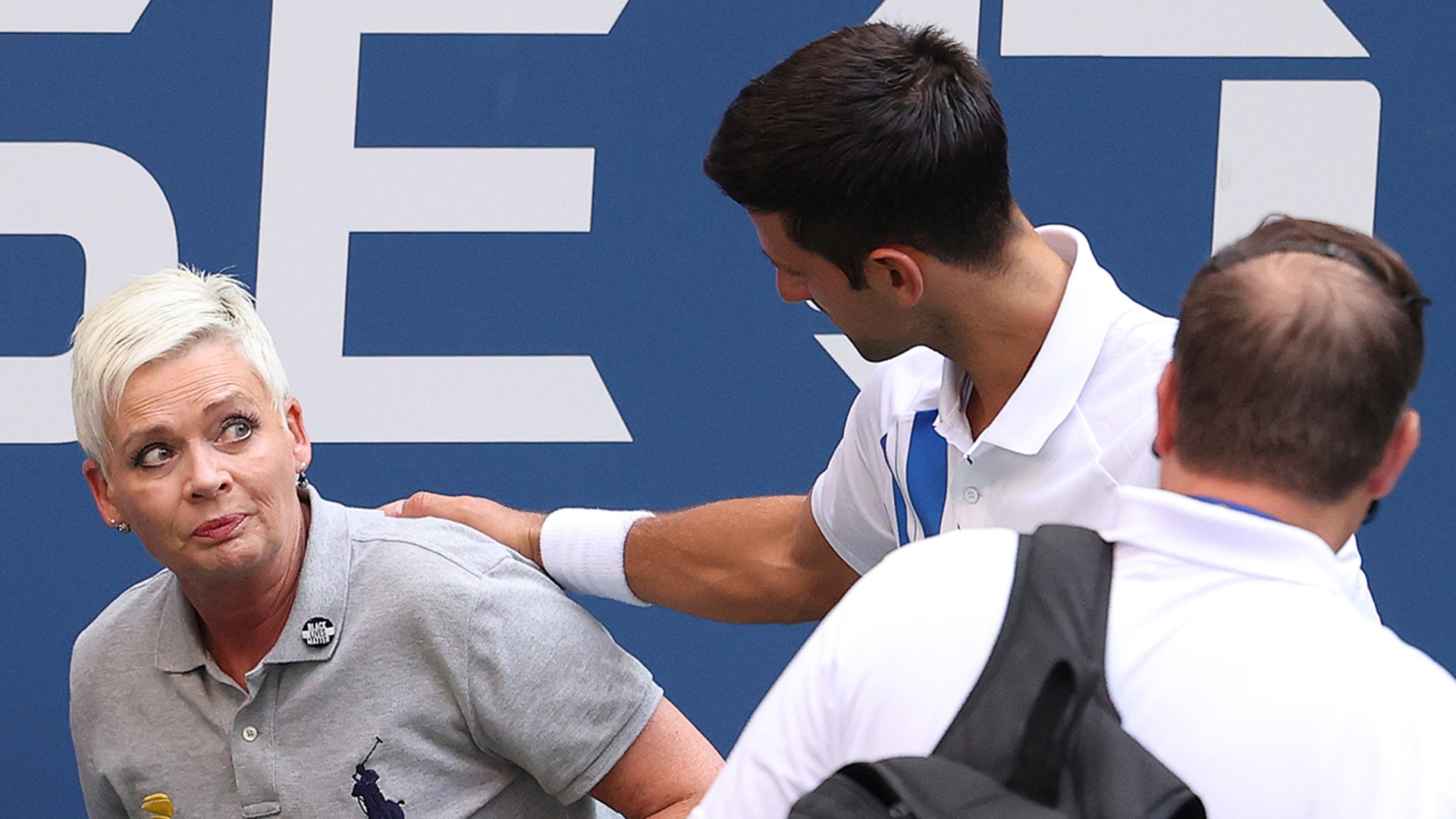 Before being disqualified, Novak Djokovic of Serbia tends to a line judge, Laura Clark, whom he hit with a ball during his fourth-round match at the 2020 US Open tennis championships in New York City, Sept 6, 2020. 