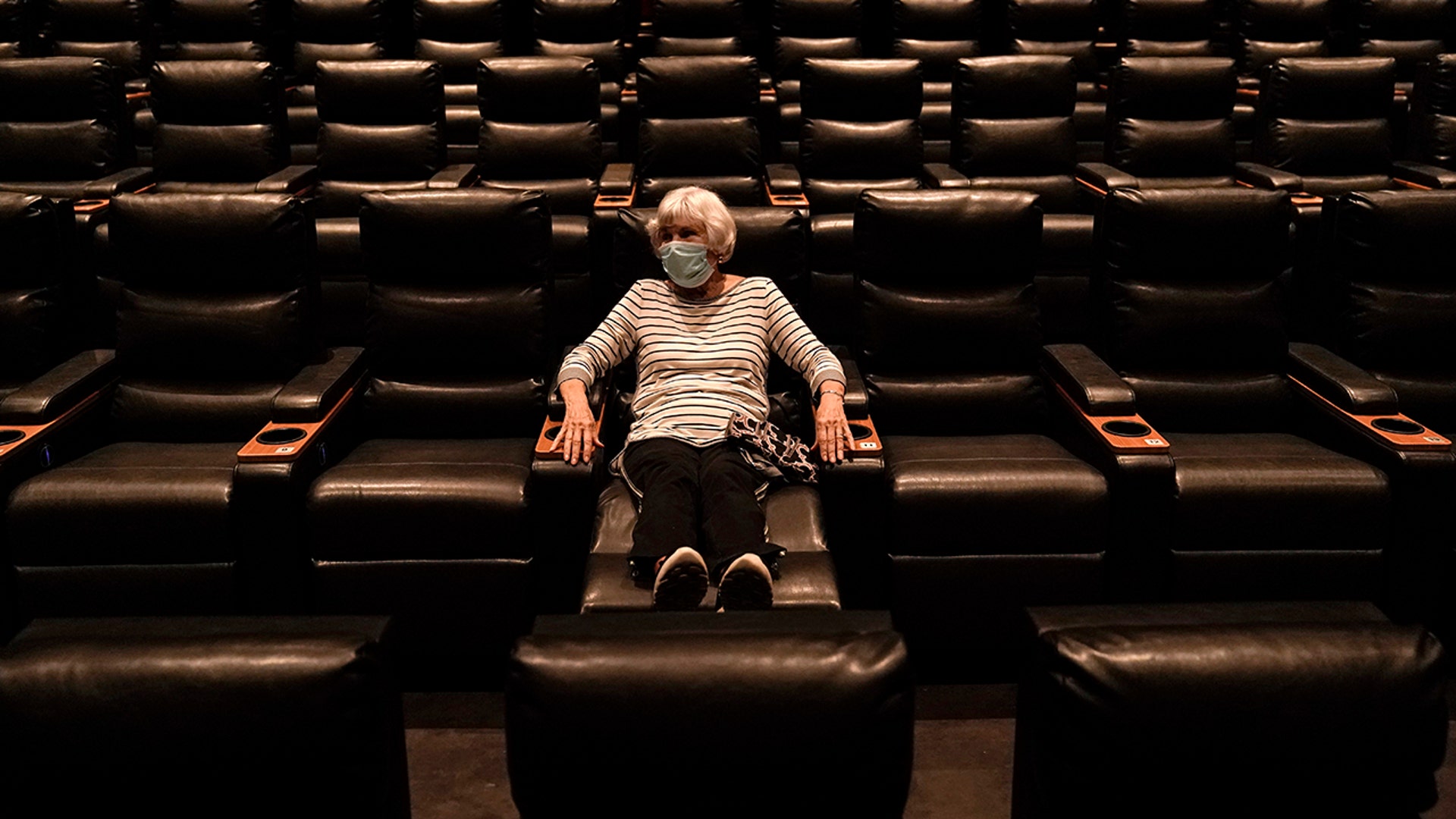 Karen Speros waits for a movie to start at a Regal movie theater in Irvine, California, Sept. 8, 2020. 