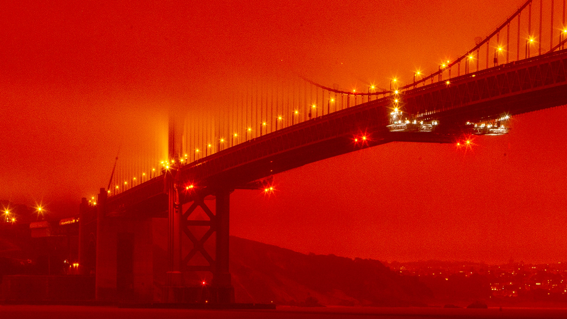 The Golden Gate Bridge is seen at 11 a.m. amid a smoky, orange hue caused by the area's ongoing wildfires in San Francisco, Sept. 9, 2020. 