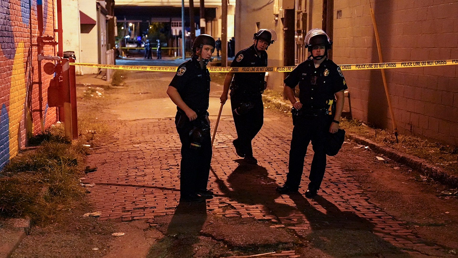 Police survey an area after a police officer was shot, Wednesday, Sept. 23, 2020, in Louisville, Ky. A grand jury has indicted one officer on criminal charges six months after Breonna Taylor was fatally shot by police in Kentucky. The jury presented its decision against fired officer Brett Hankison Wednesday to a judge in Louisville, where the shooting took place.