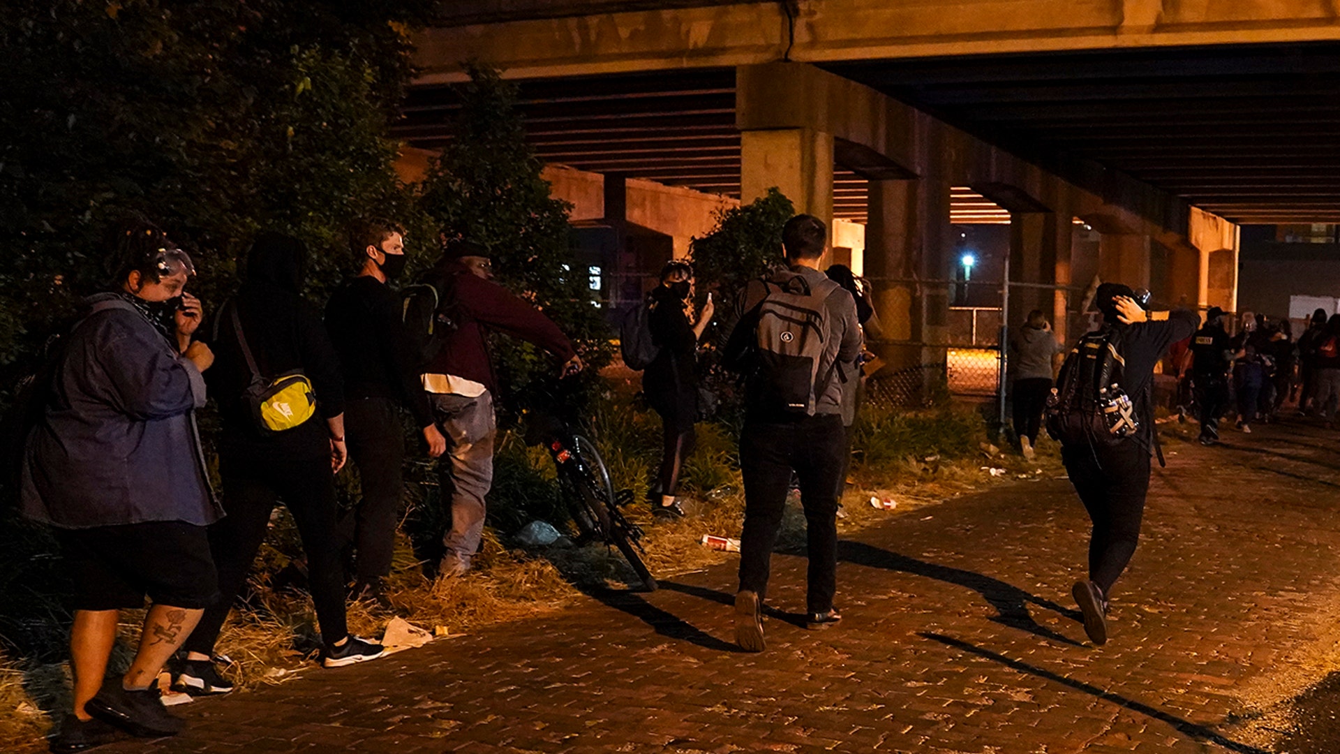Protesters react to gunfire, Wednesday, Sept. 23, 2020, in Louisville, Ky. A police officer was shot in the evening. A grand jury has indicted one officer on criminal charges six months after Breonna Taylor was fatally shot by police in Kentucky.
