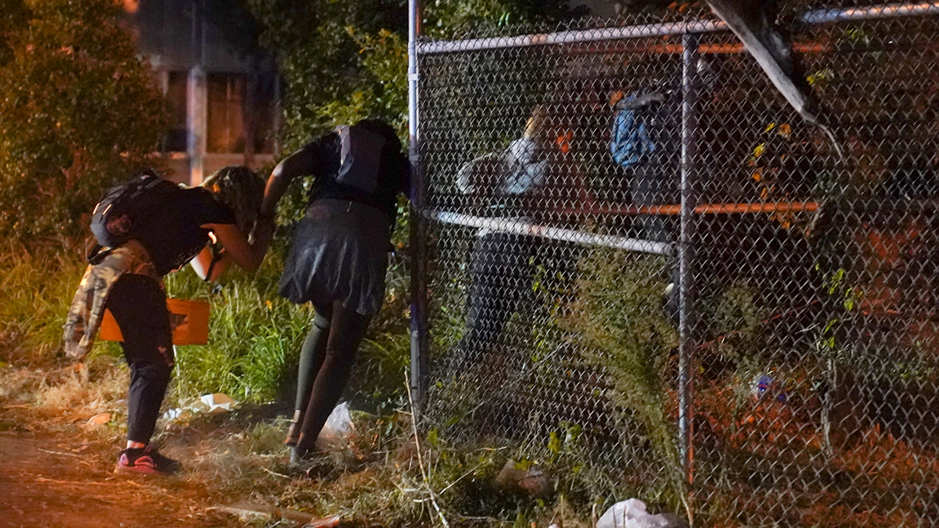 Protesters run after hearing gunfire, Wednesday, Sept. 23, 2020, in Louisville, Ky. A police officer was shot in the evening. A grand jury has indicted one officer on criminal charges six months after Breonna Taylor was fatally shot by police in Kentucky.