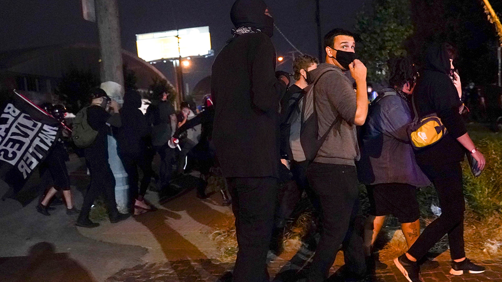 Protesters react to gunfire, Wednesday, Sept. 23, 2020, in Louisville, Ky. A police officer was shot in the evening. A grand jury has indicted one officer on criminal charges six months after Breonna Taylor was fatally shot by police in Kentucky.