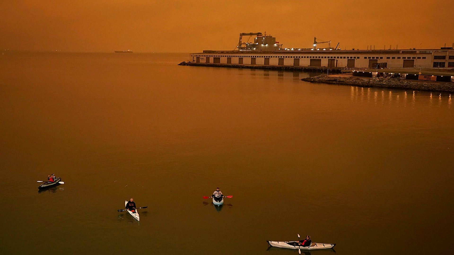 People in kayaks paddle in McCovey Cove outside Oracle Park during the sixth inning of a baseball game between the San Francisco Giants and the Seattle Mariners on Wednesday, Sept. 9, 2020, in San Francisco.