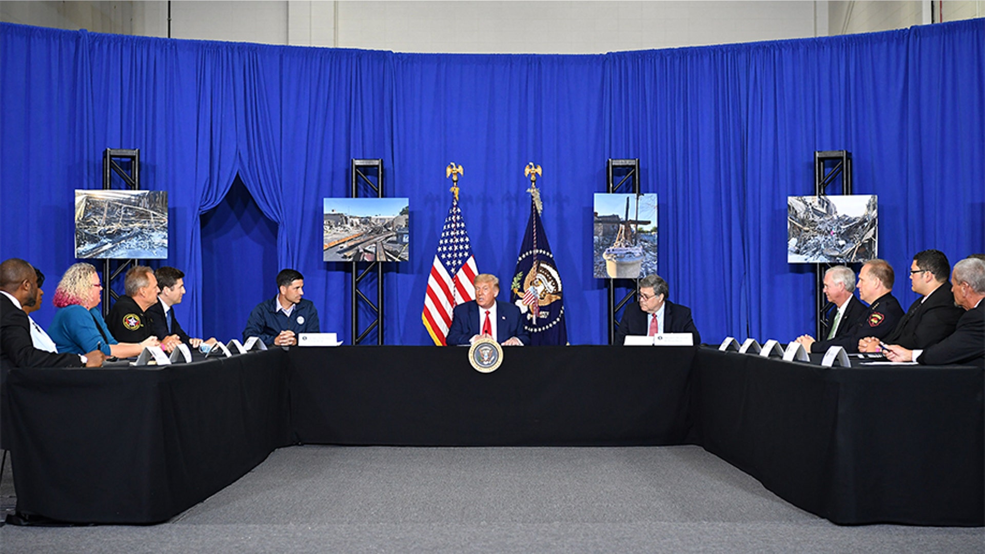 President Trump (C) with Attorney General William Barr (left of Trump) and Acting Homeland Security Secretary Chad Wolf (right of Trump), speaks to officials during a roundtable discussion on community safety, at Mary D. Bradford High School.