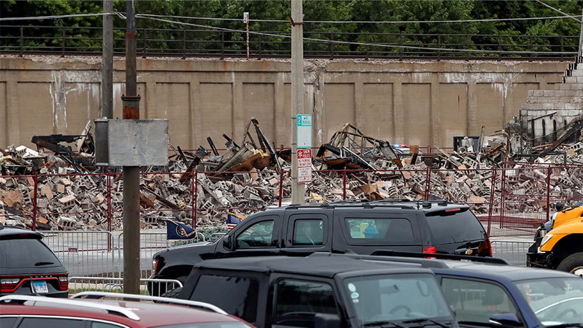 President Trump's motorcade passes a burnt building during his visit to Kenosha, Wis. 