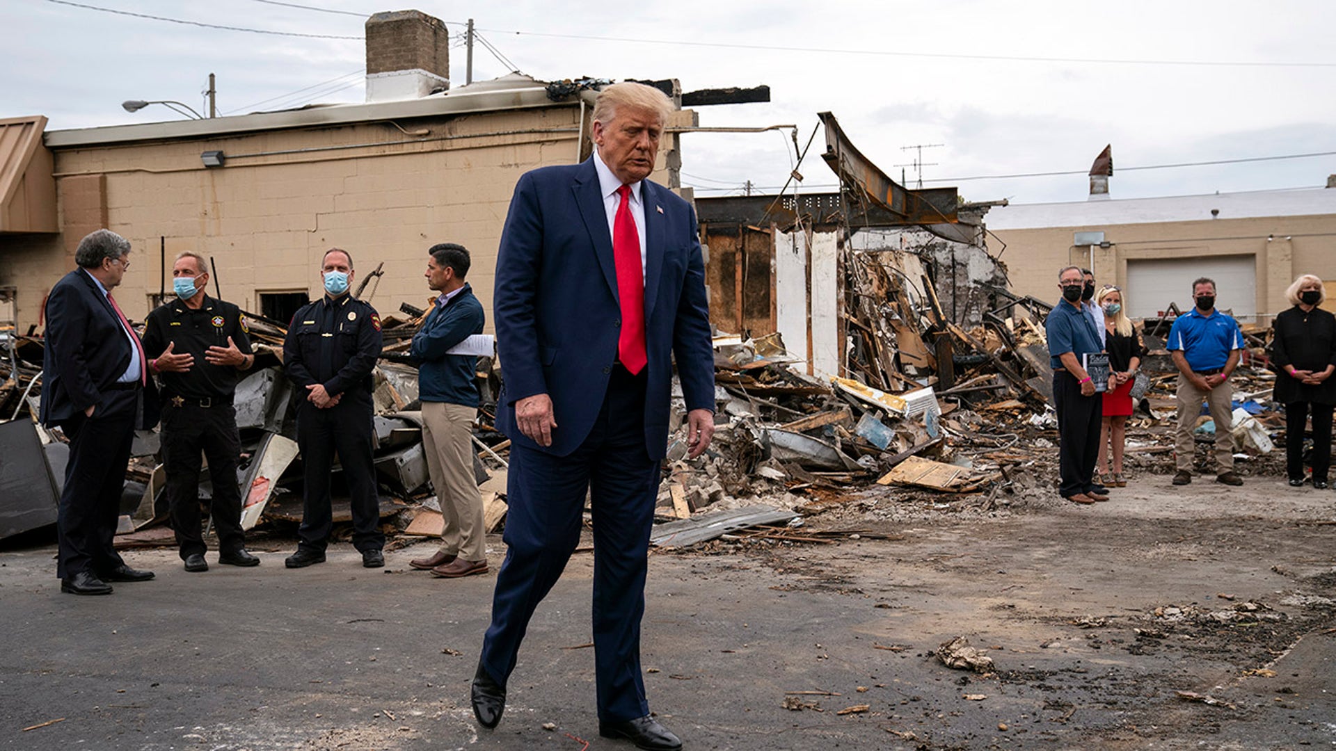 President Donald Trump tours an area Tuesday, Sept. 1, 2020, that was damaged during demonstrations after a police officer shot Jacob Blake in Kenosha, Wis. (AP Photo/Evan Vucci)