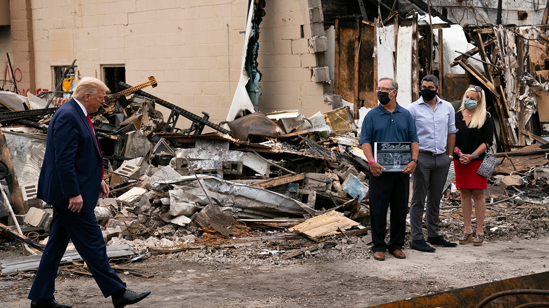 President Donald Trump walks over to talk to business owners Tuesday, Sept. 1, 2020, as he tours an area damaged during demonstrations after a police officer shot Jacob Blake in Kenosha, Wis. (AP Photo/Evan Vucci)