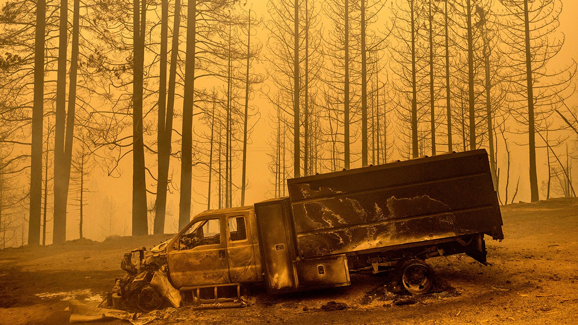 A scorched truck rests on Highway 168 after the Creek Fire burned through the area on Tuesday, Sept. 8, 2020, in Fresno County, Calif.