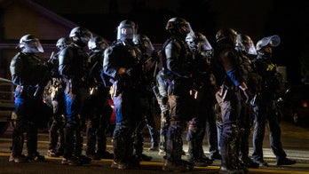 Portland police declare riot after protesters march on Mayor Ted Wheeler's residence, burning debris thrown into building