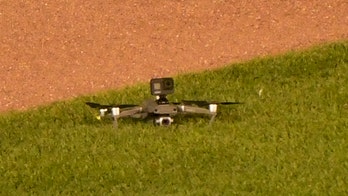 Drone lands in outfield at Wrigley Field, causing delay