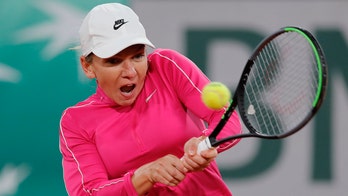 Former champ Halep reaches French Open 2nd round, Goffin out