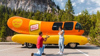 Couple gets engaged at Yellowstone National Park in front of Oscar Mayer Wienermobile