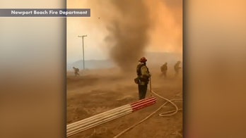 California firefighters battling wildfire face gusty winds, smoke dust devils