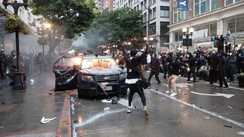 Man charged with arson in attempt to set police cars on fire during Seattle protest