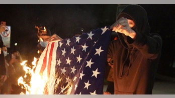 Portland unrest prompts arrests; objects thrown at officers, flag burned: reports