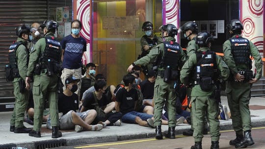 Hong Kong police arrest dozens of protesters as government delays elections: report