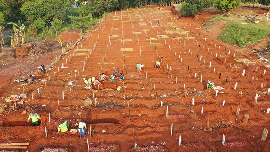 Indonesian official orders coronavirus victims' graves be dug by people busted without masks