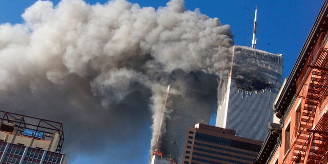 In this Sept. 11, 2001, file photo, smoke rises from the burning twin towers of the World Trade Center after hijacked planes crashed into the towers, in New York City.  (AP Photo/Richard Drew, File)