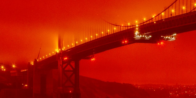 In this photo provided by Frederic Larson, the Golden Gate Bridge is seen at 11 a.m. PT, Sept. 9, in San Francisco, amid a smoky, orange hue caused by the ongoing wildfires. (Frederic Larson via AP)