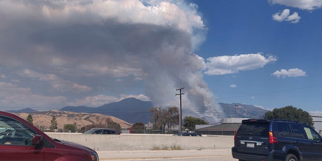 A plume of smoke from the El Dorado Fire is seen from the Interstate 10 in Loma Linda, Calif., Saturday, Sept. 5, 2020.  (AP Photo/Ringo H.W. Chiu)