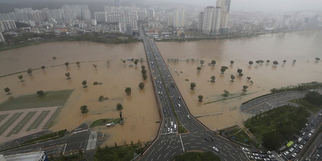 A part of a road and riverside near the Taehwa River are flooded due to heavy rain in Ulsan, South Korea, Monday, Sept. 7, 2020.