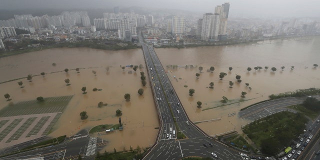A part of a road and riverside near the Taehwa River are flooded due to heavy rain in Ulsan, South Korea, Monday, Sept. 7, 2020.