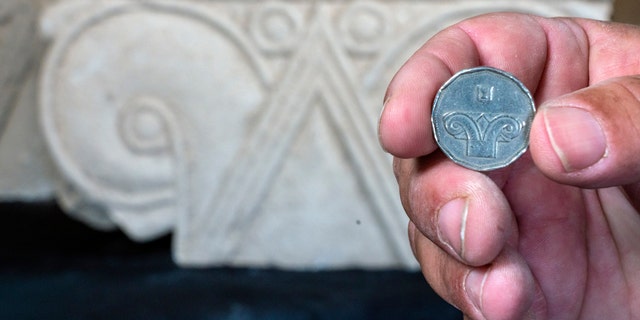 An Israeli five-shekel coin against the background of the capital discovered.