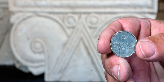 An Israeli five-shekel coin against the background of the capital discovered.