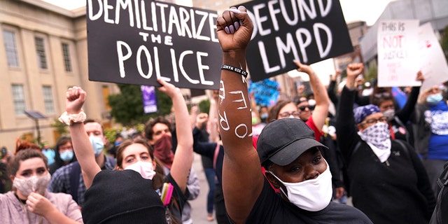 Protesters speak, Wednesday, Sept. 23, 2020, in Louisville, Ky. A grand jury has indicted one officer on criminal charges six months after Breonna Taylor was fatally shot by police in Kentucky. (AP Photo/John Minchillo)