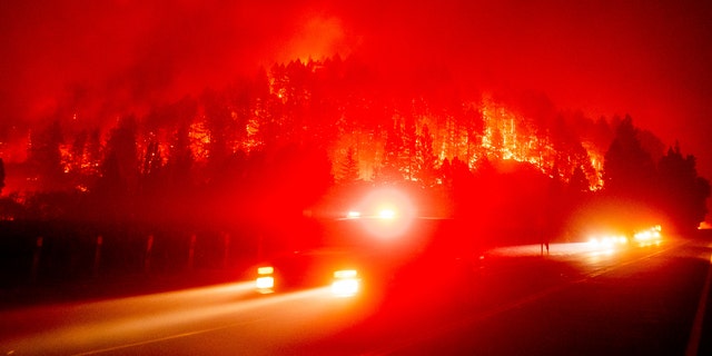 An emergency vehicle drives along Silverado Trail as the Glass Fire burns in St. Helena, Calif., Sunday, Sept. 27, 2020.
