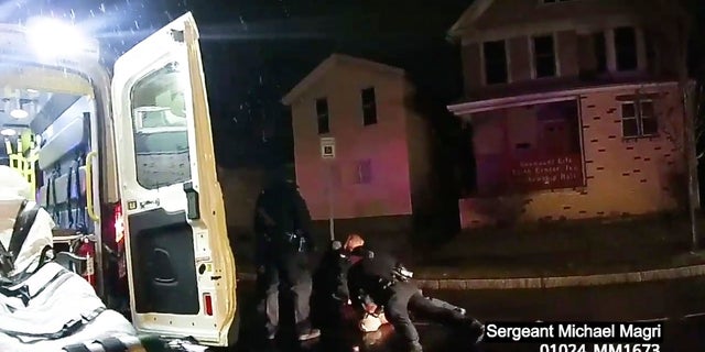 Rochester police officers holding down Daniel Prude, who had run naked through the streets of the western New York city, this past March. He died of asphyxiation after police put a hood over his head, then pressed his face into the pavement for two minutes, according to video and records released last week by the man's family.